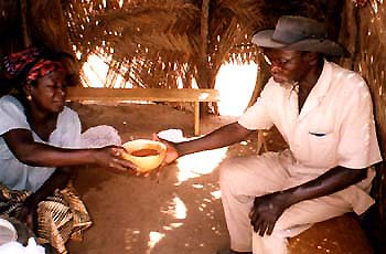 Serving a calabash of dolo near Ougadougou (Burkina)